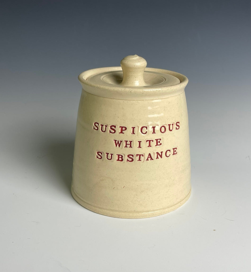 Suspicious white substance jar.